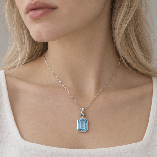 A Window Left Open — blue topaz pendant, AI-assisted editorial wearing view [asset:8994ae7ba8d2]