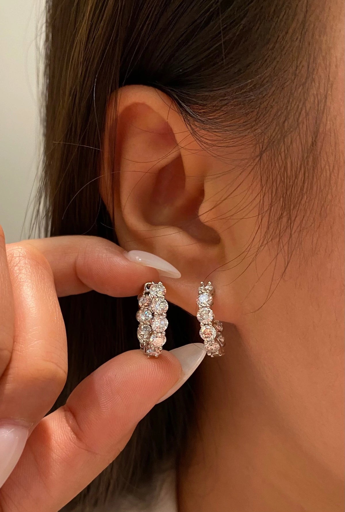 Round diamond hoop earrings shown worn and held for a size comparison, view 3