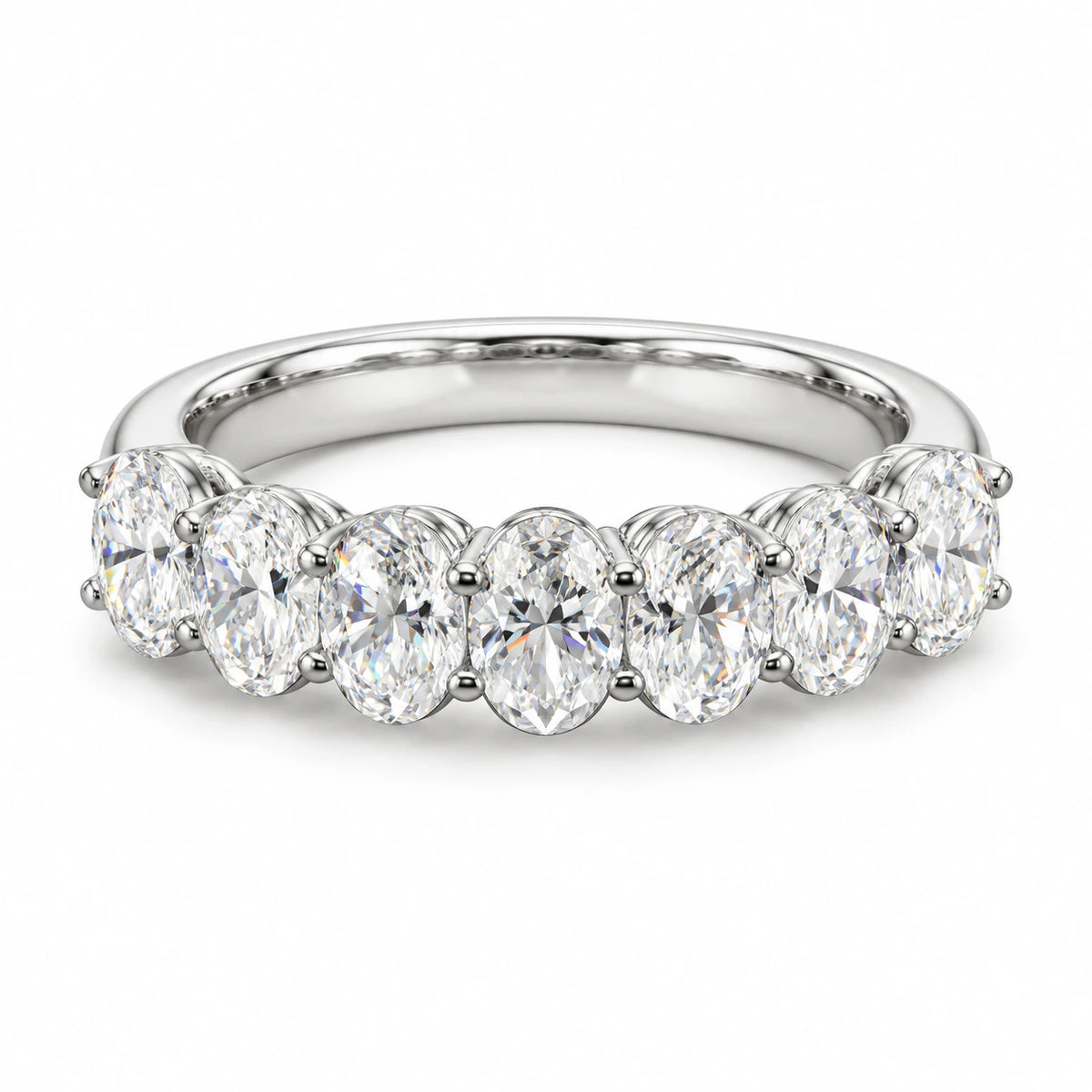 Seven oval-cut lab-grown diamonds set in an 18K white gold band on white background