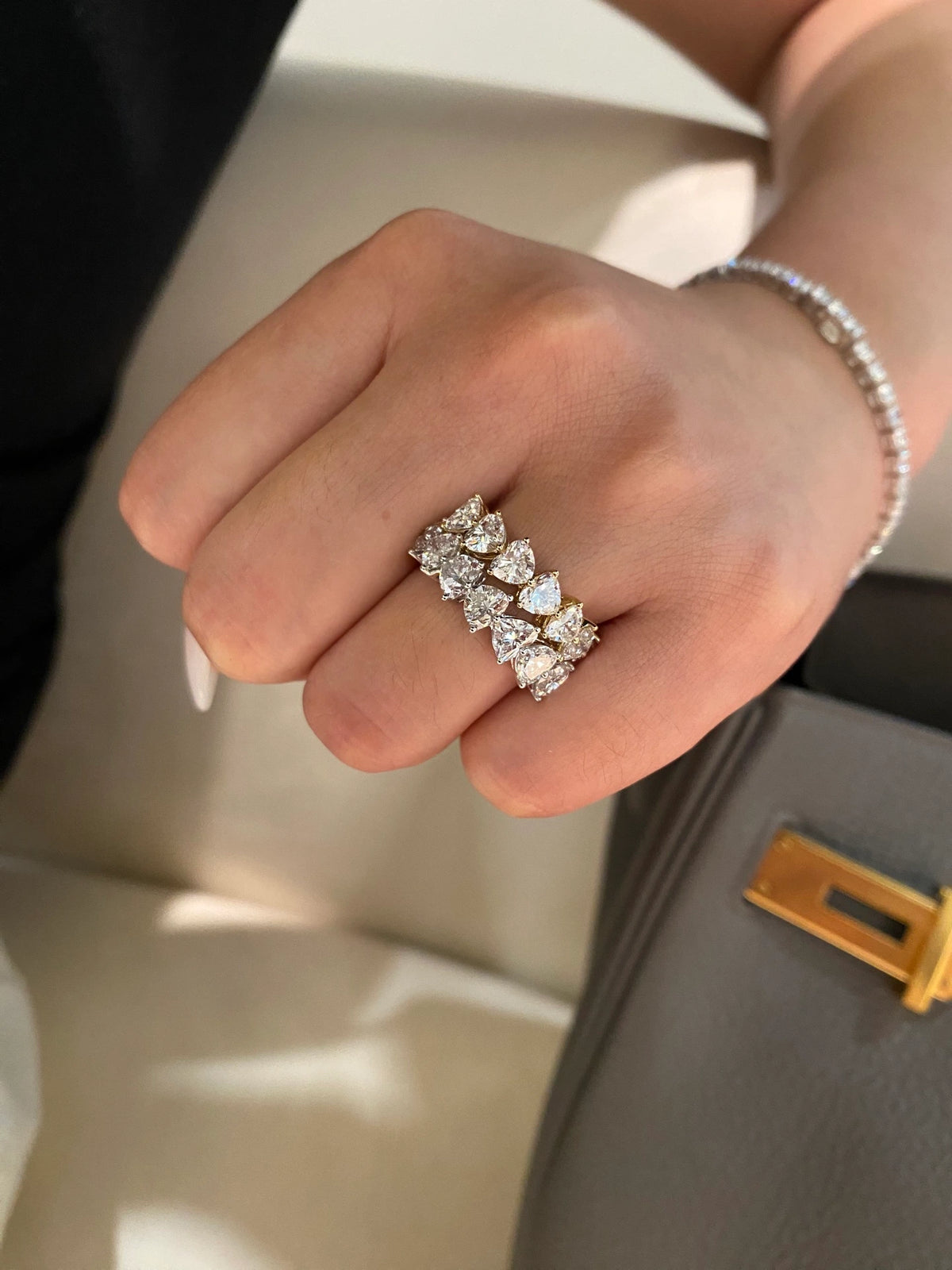 Heart-cut diamond bands in 18K yellow and white gold worn on a hand, original view 9