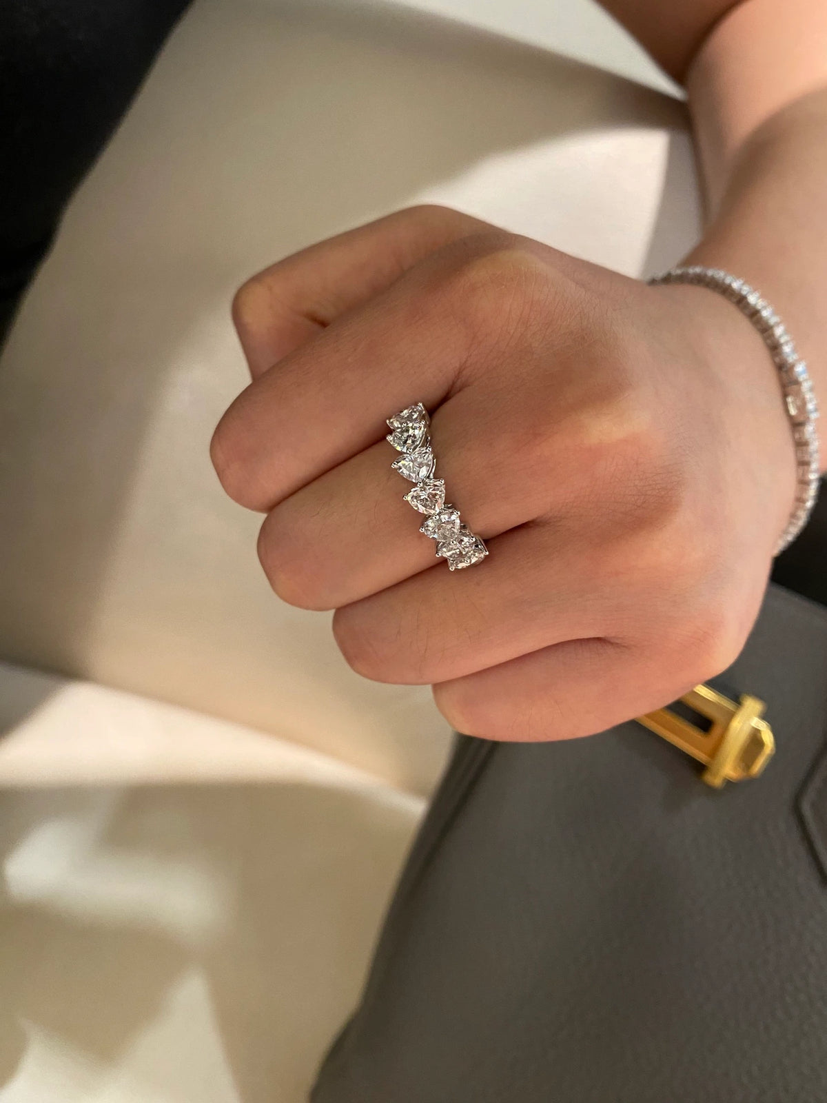 Heart-cut diamond band in 18K white gold worn on a hand, original view 7