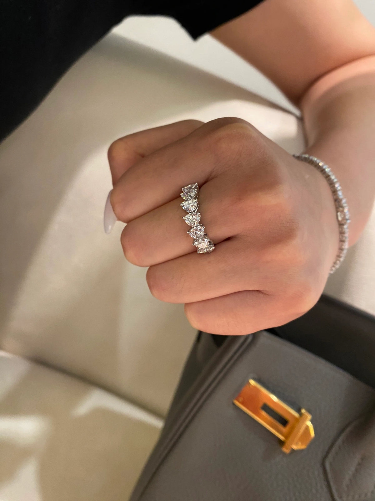 Heart-cut diamond band in 18K white gold worn on a hand, original view 8