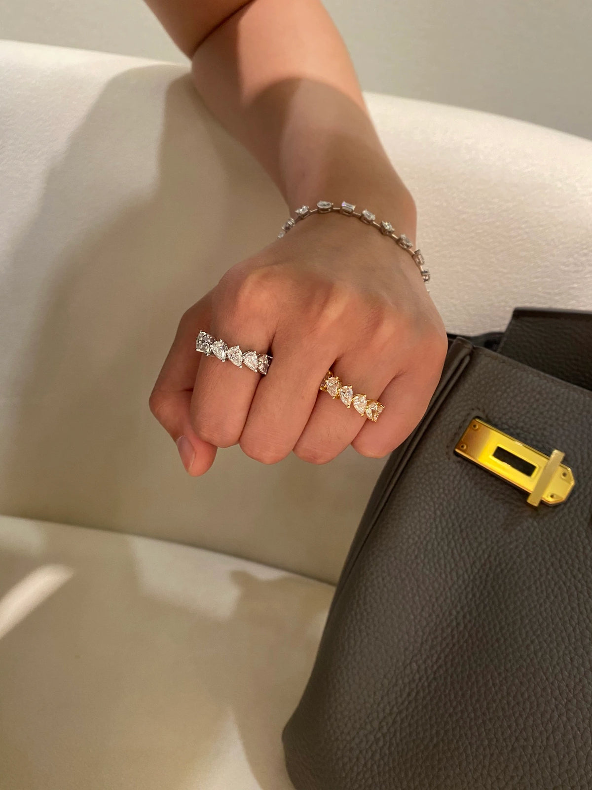 Pear-cut diamond bands in 18K yellow and white gold worn on a hand, original view 7
