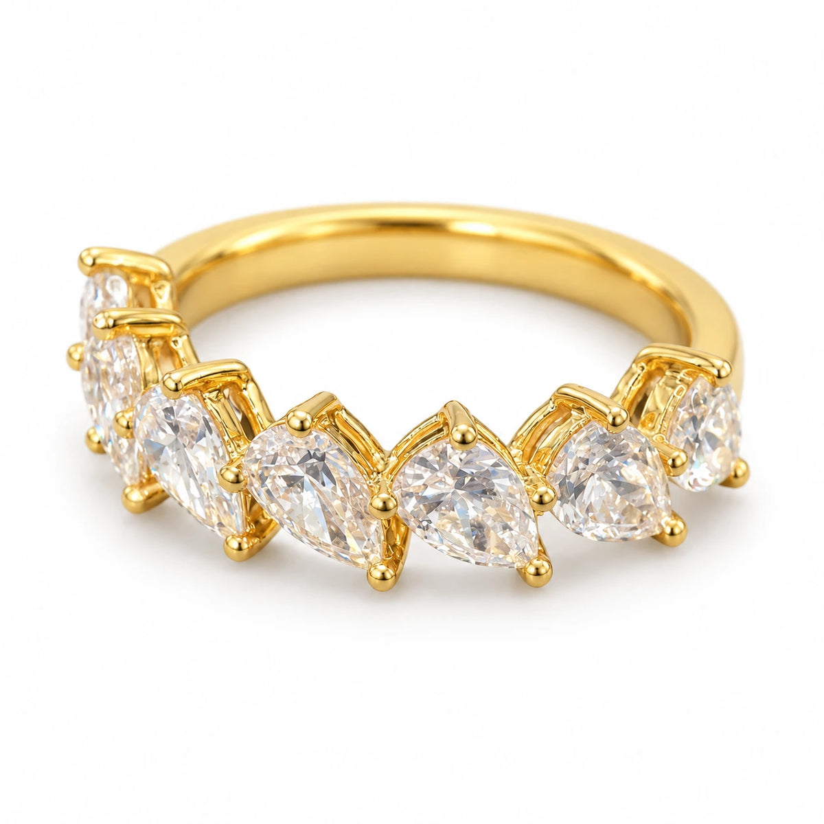 Seven pear-cut lab-grown diamonds set in an 18K yellow gold band on white background