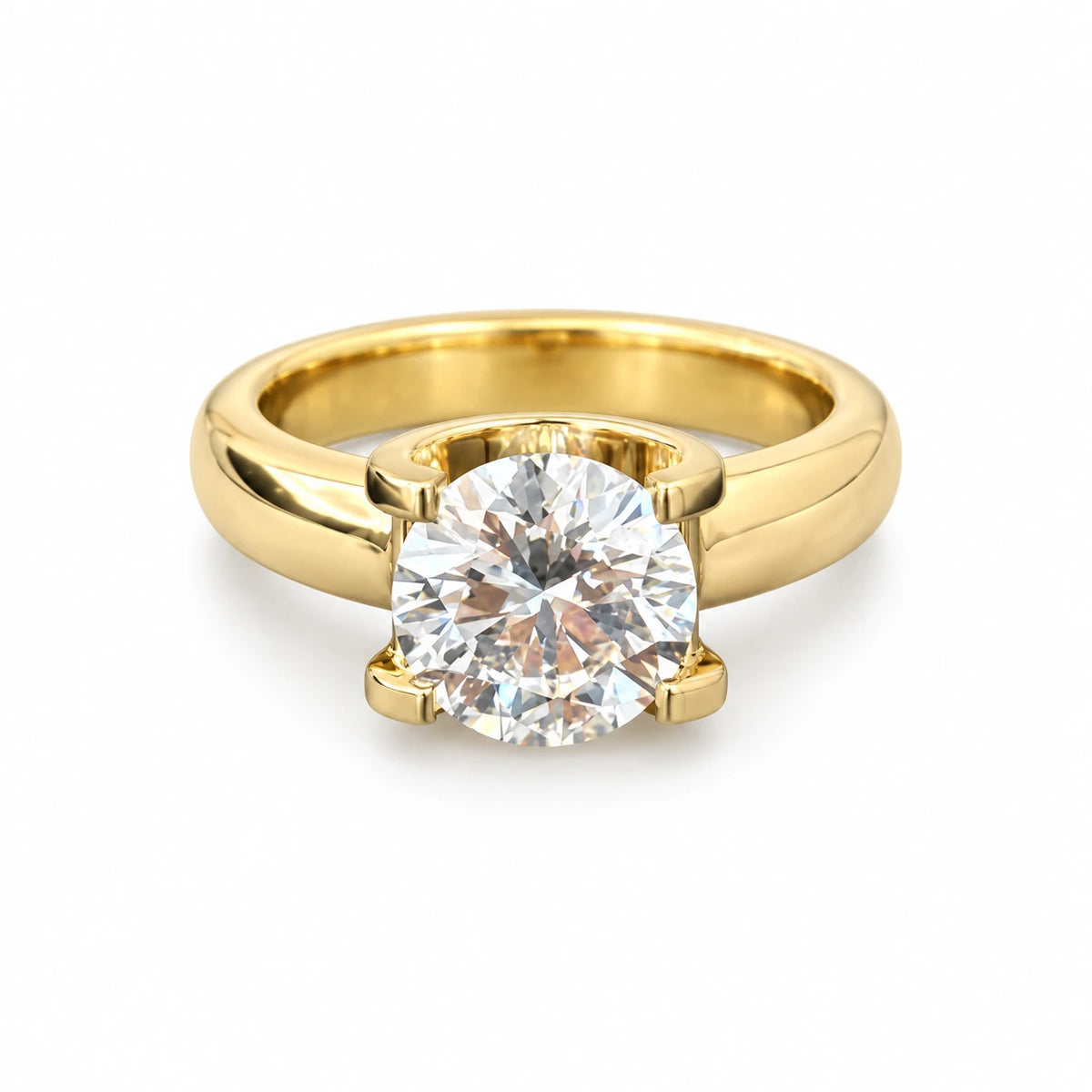 Round lab-grown diamond in a sculpted 18K yellow gold ring on white background
