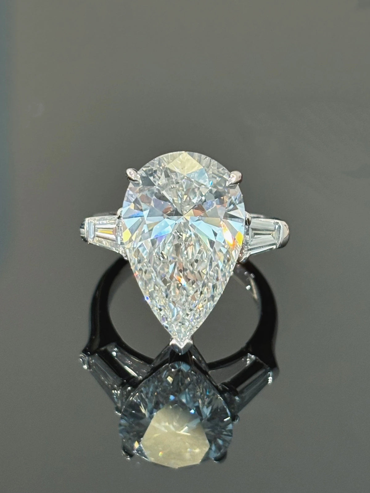 Pear-cut diamond ring with tapered baguette side stones in 18K white gold, original view 2