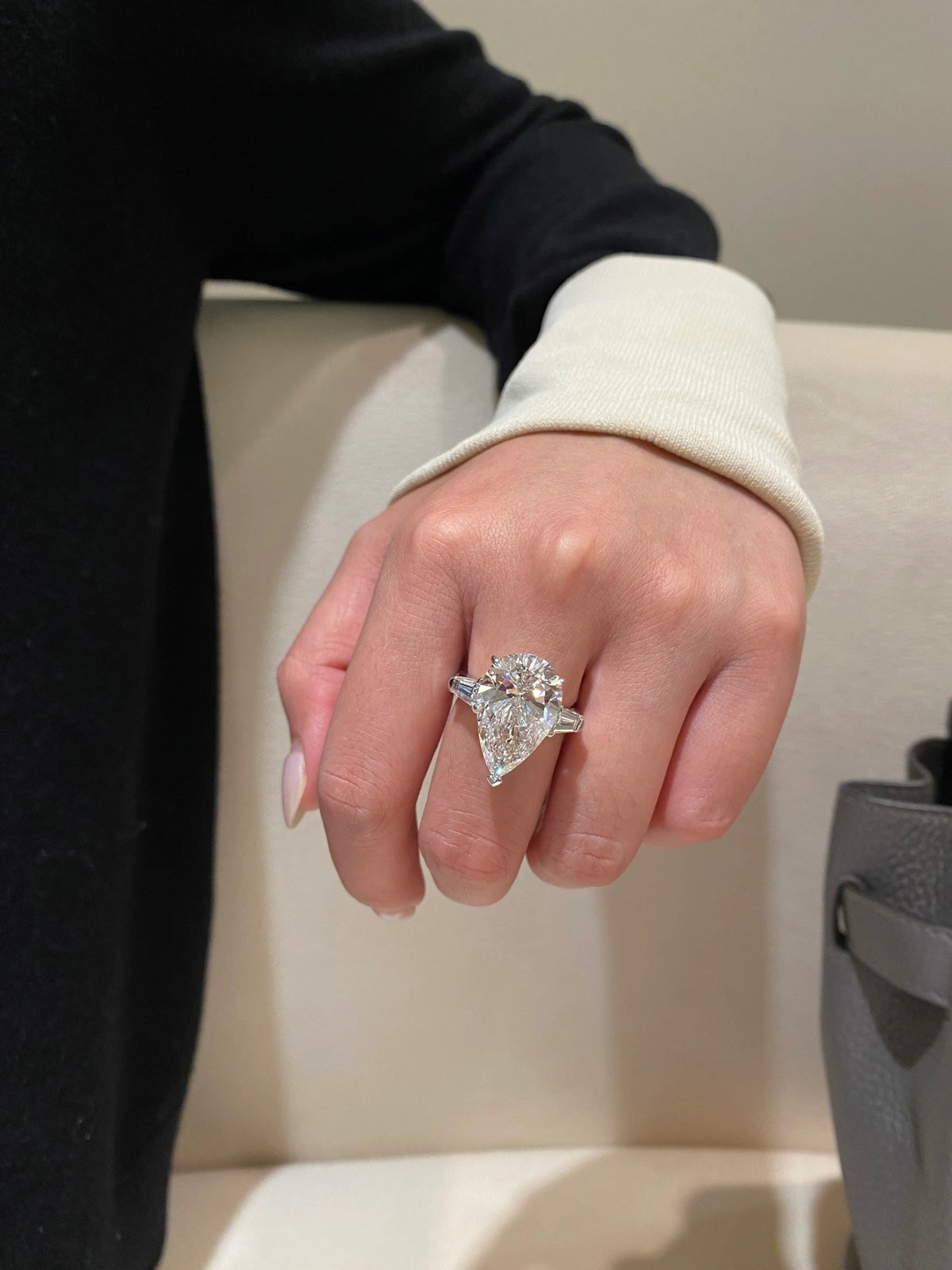 Pear-cut diamond ring with tapered baguette side stones in 18K white gold, original view 3