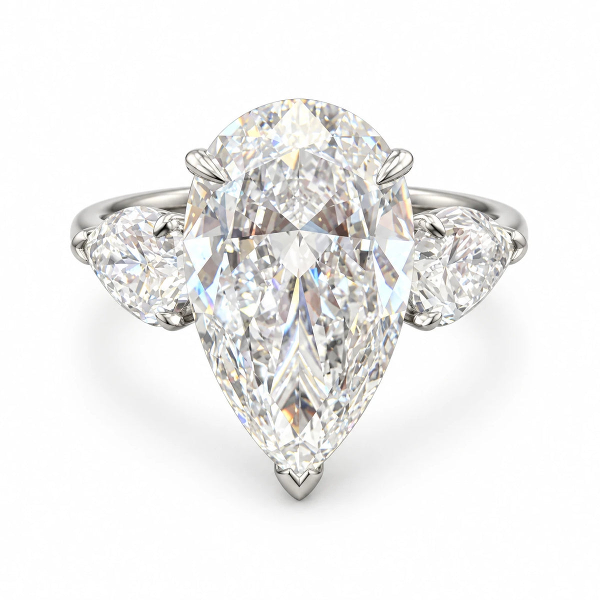 Pear-cut diamond ring with two accent diamonds in 18K white gold on white background