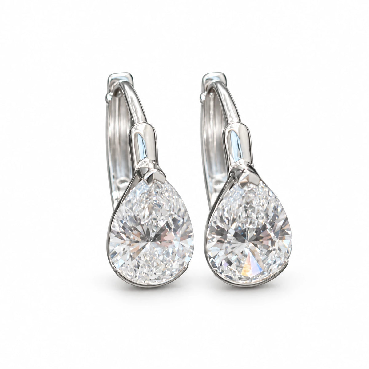 Pair of pear-cut lab-grown diamond earrings in 18K white gold on white background