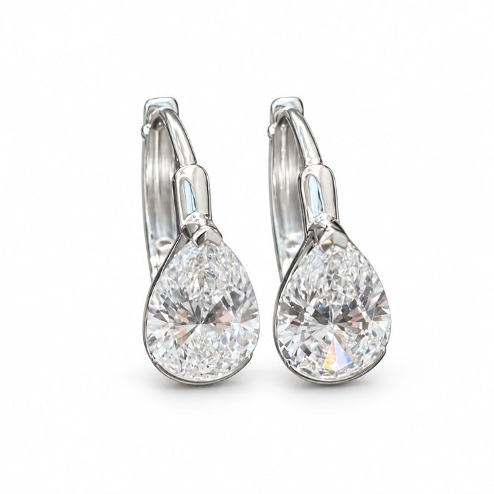 Pair of pear-cut lab-grown diamond earrings in 18K white gold on white background