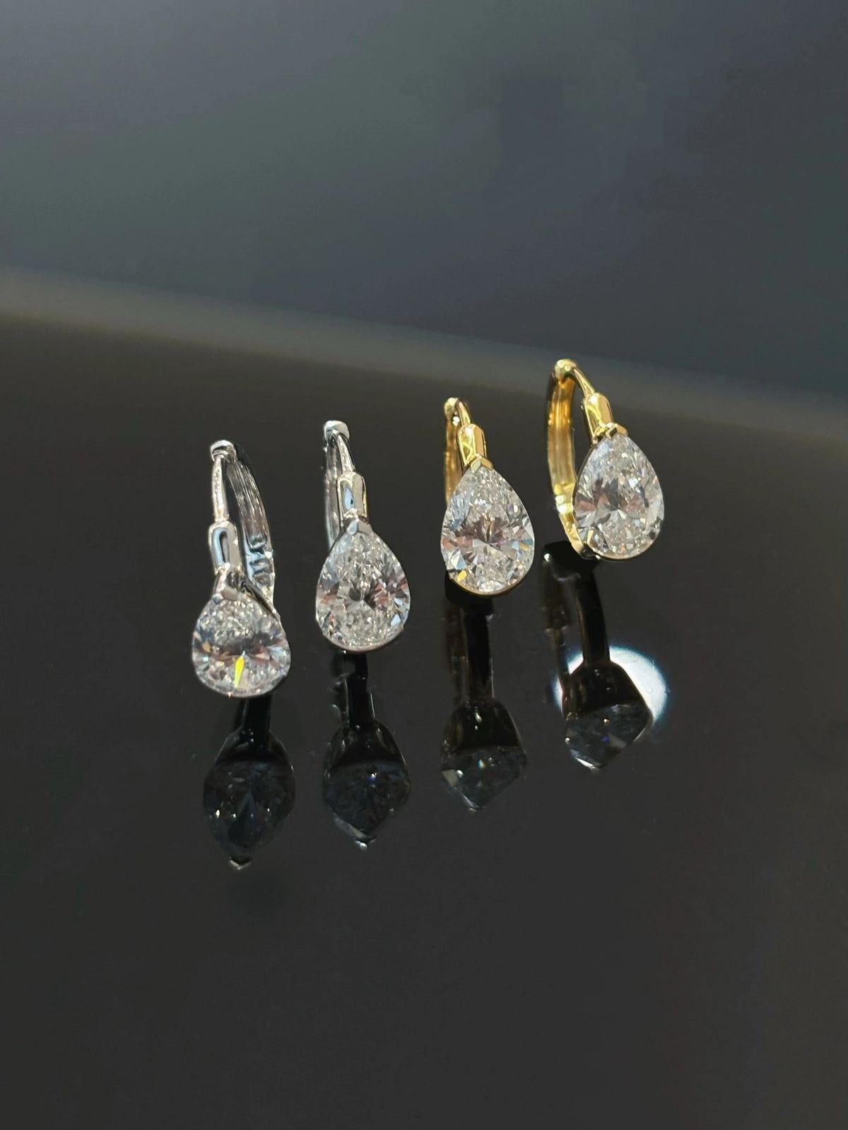 Pear-cut diamond earrings in 18K yellow and white gold, both color options shown