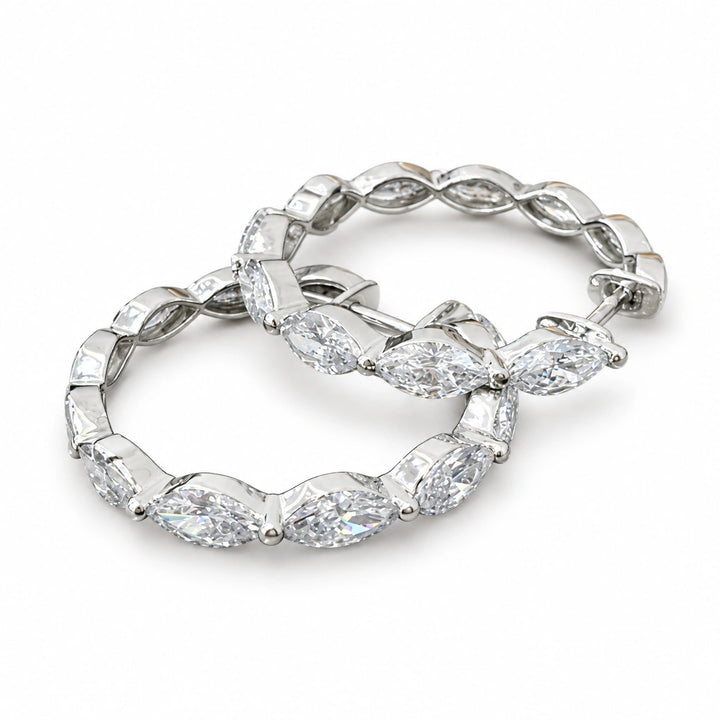Pair of marquise-cut lab-grown diamond hoop earrings in 18K white gold on white background