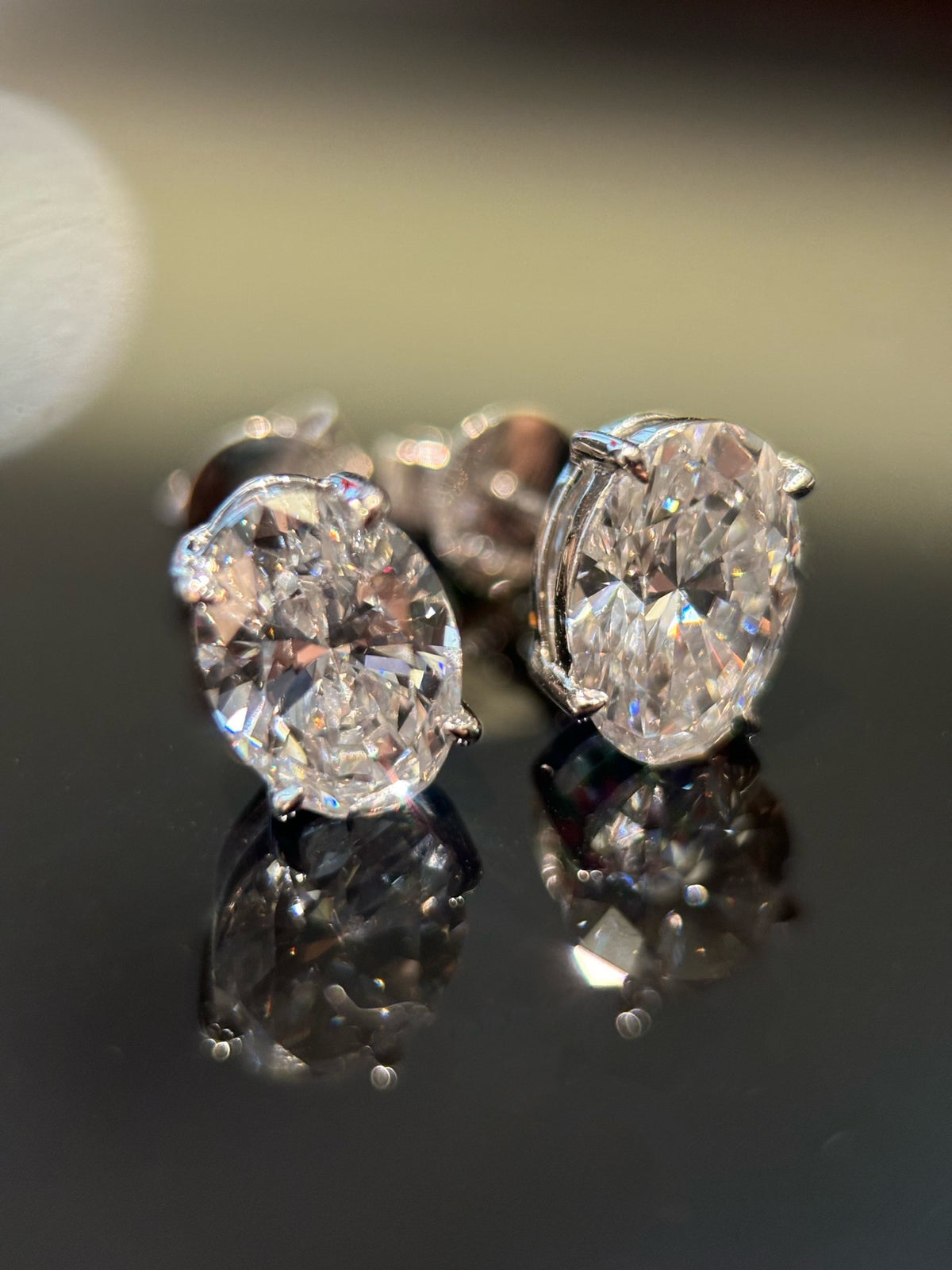 Pair of oval-cut lab-grown diamond stud earrings in 18K white gold, original detail view 1