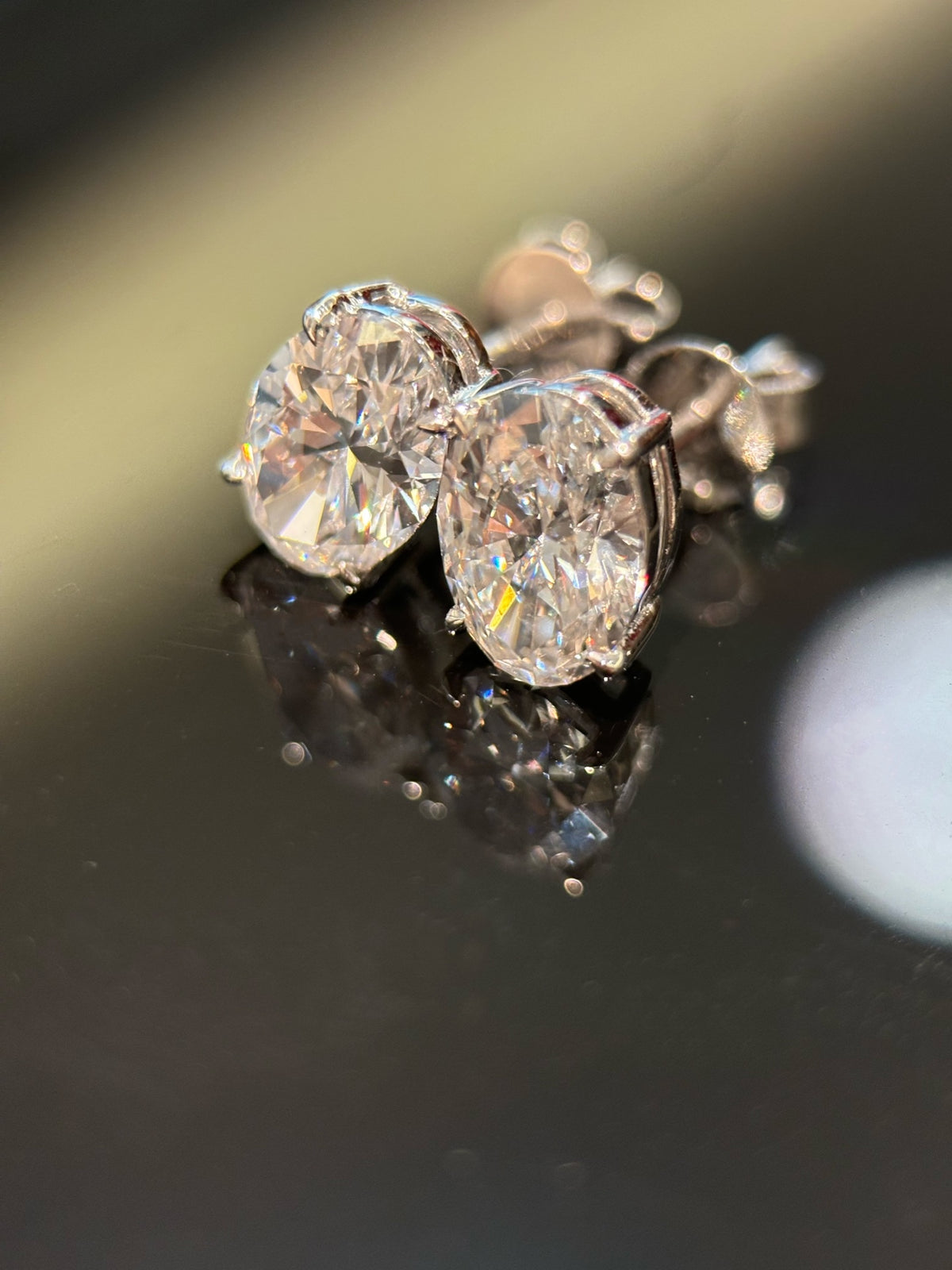 Pair of oval-cut lab-grown diamond stud earrings in 18K white gold, original detail view 2