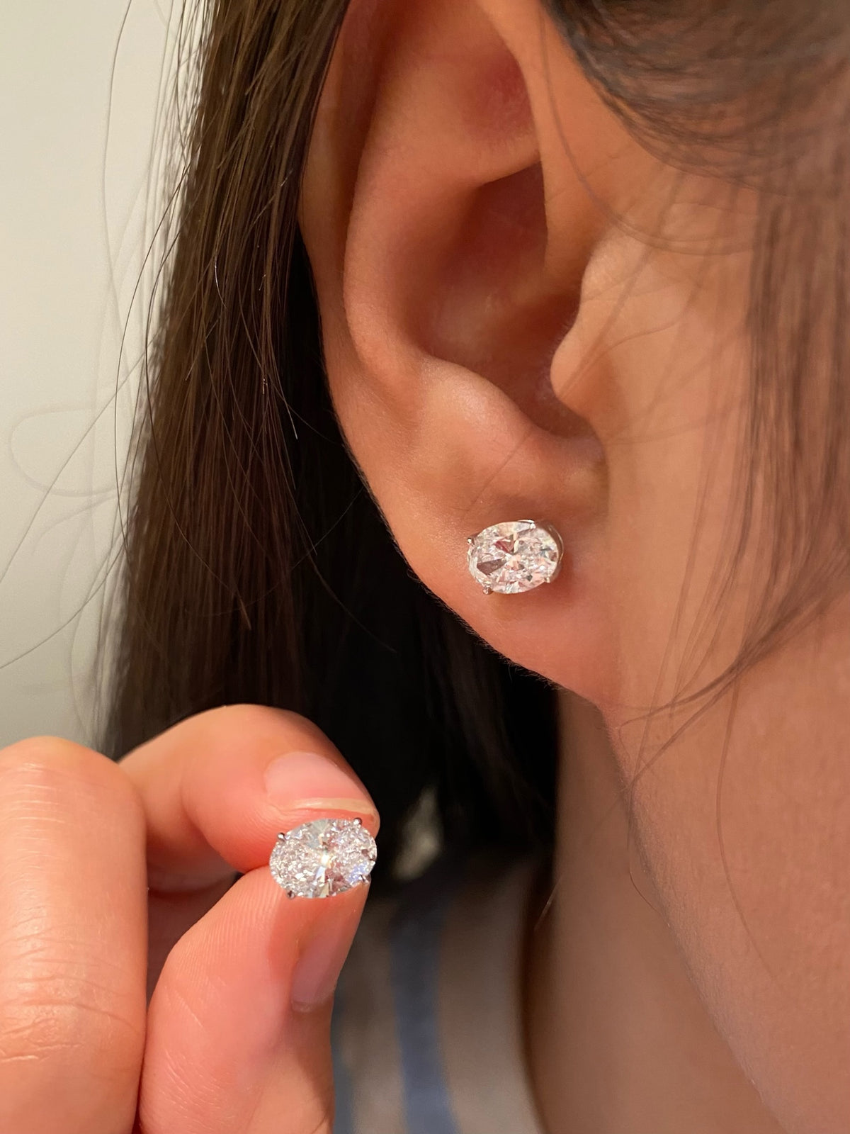 Oval-cut lab-grown diamond stud earrings in 18K white gold, original wearing view 2