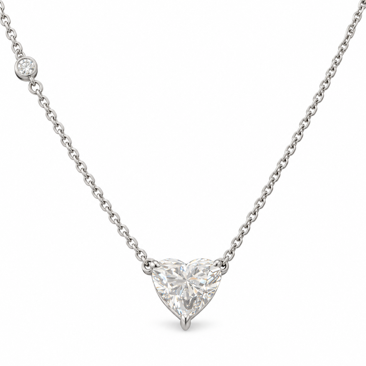 Heart-cut lab-grown diamond necklace in 18K white gold with a round diamond accent on white background