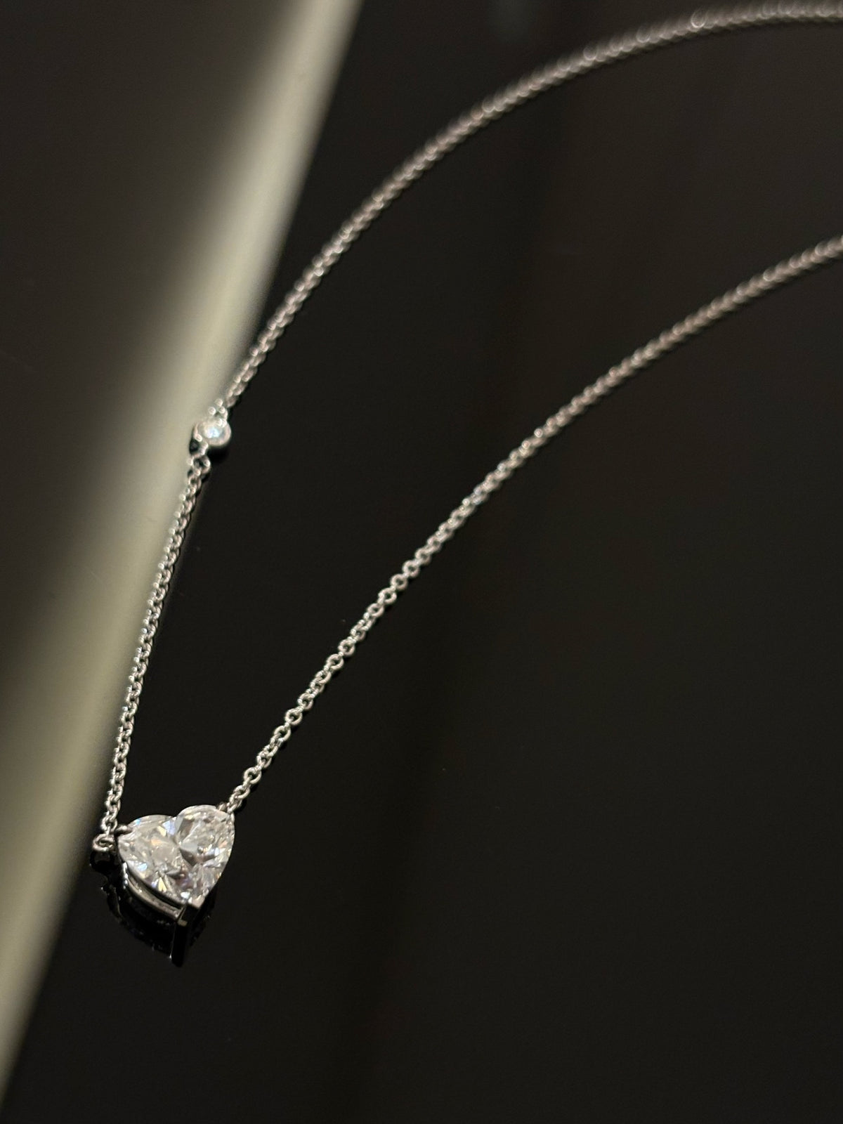 Heart-cut lab-grown diamond necklace with a round diamond accent, original detail view 1