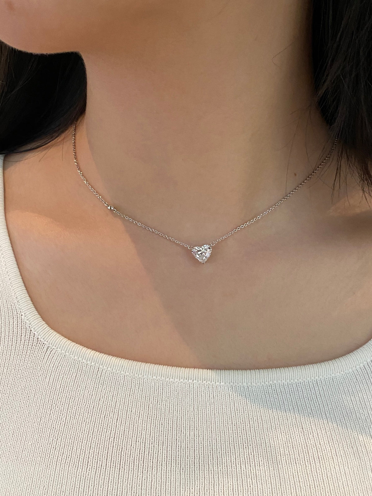 Heart-cut lab-grown diamond necklace with a round diamond accent, original wearing view 2