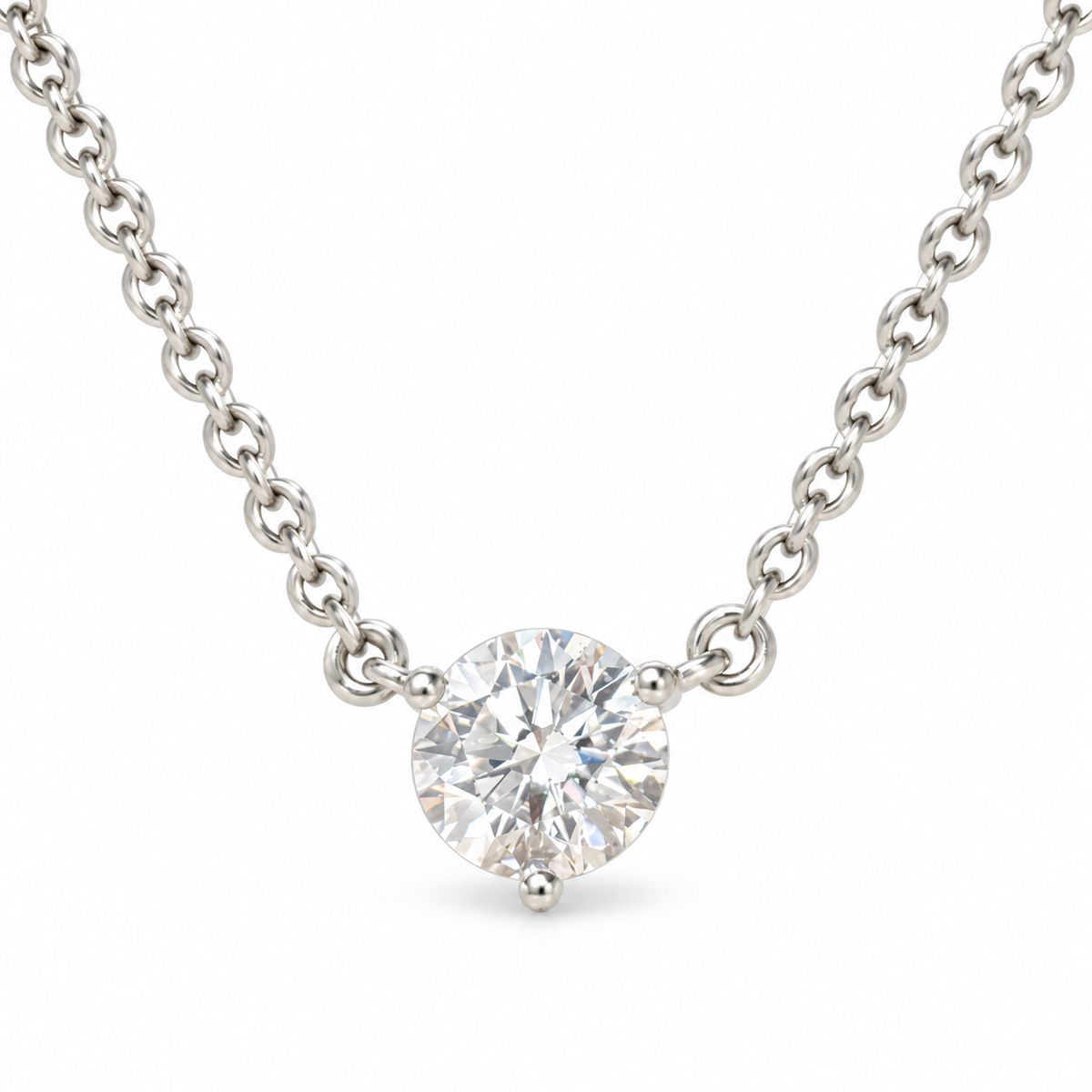 Round solitaire lab-grown diamond in an 18K white gold three-prong necklace, white background