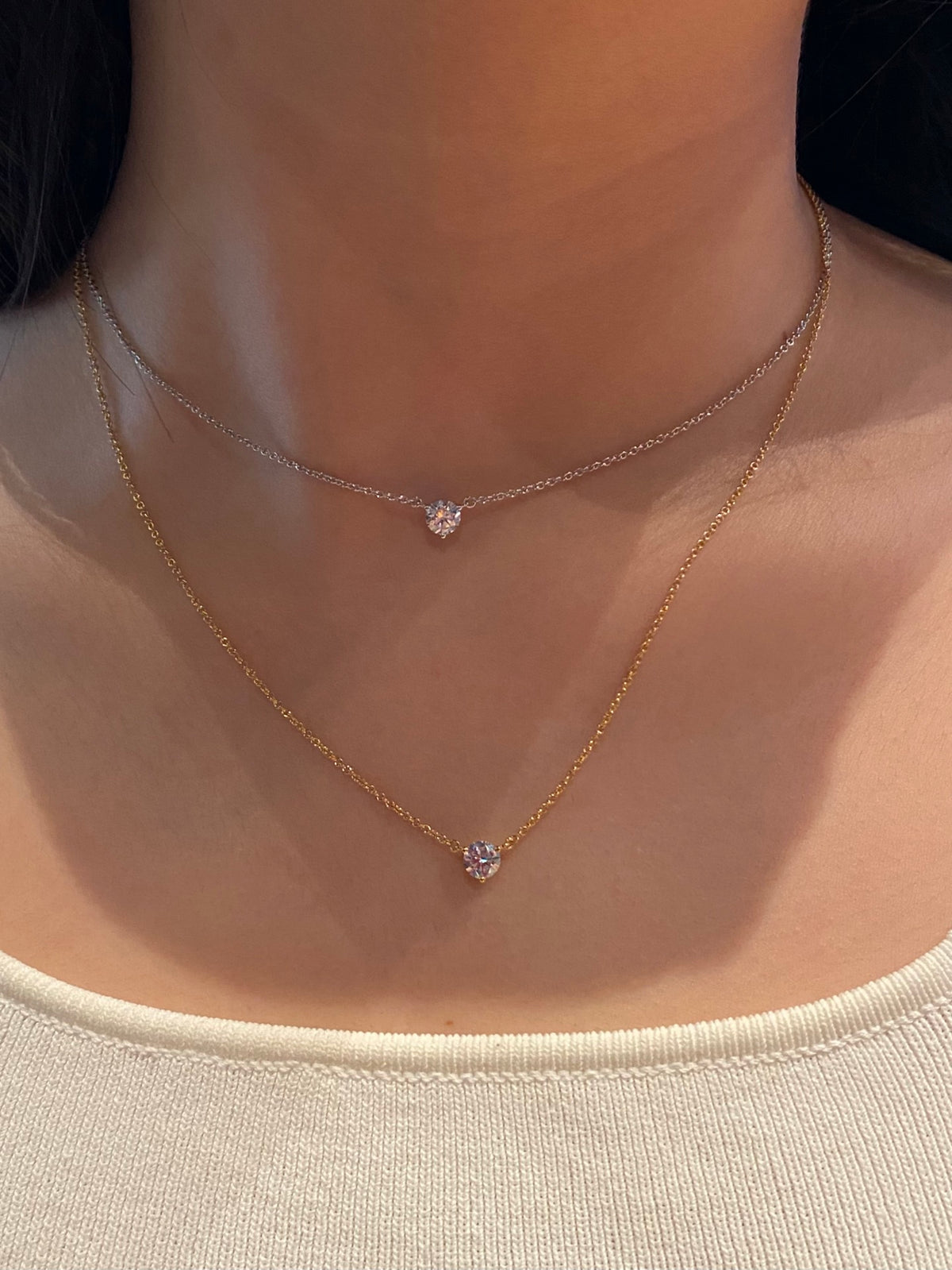 Layered styling with the 18K yellow and white gold solitaire necklaces, each sold individually
