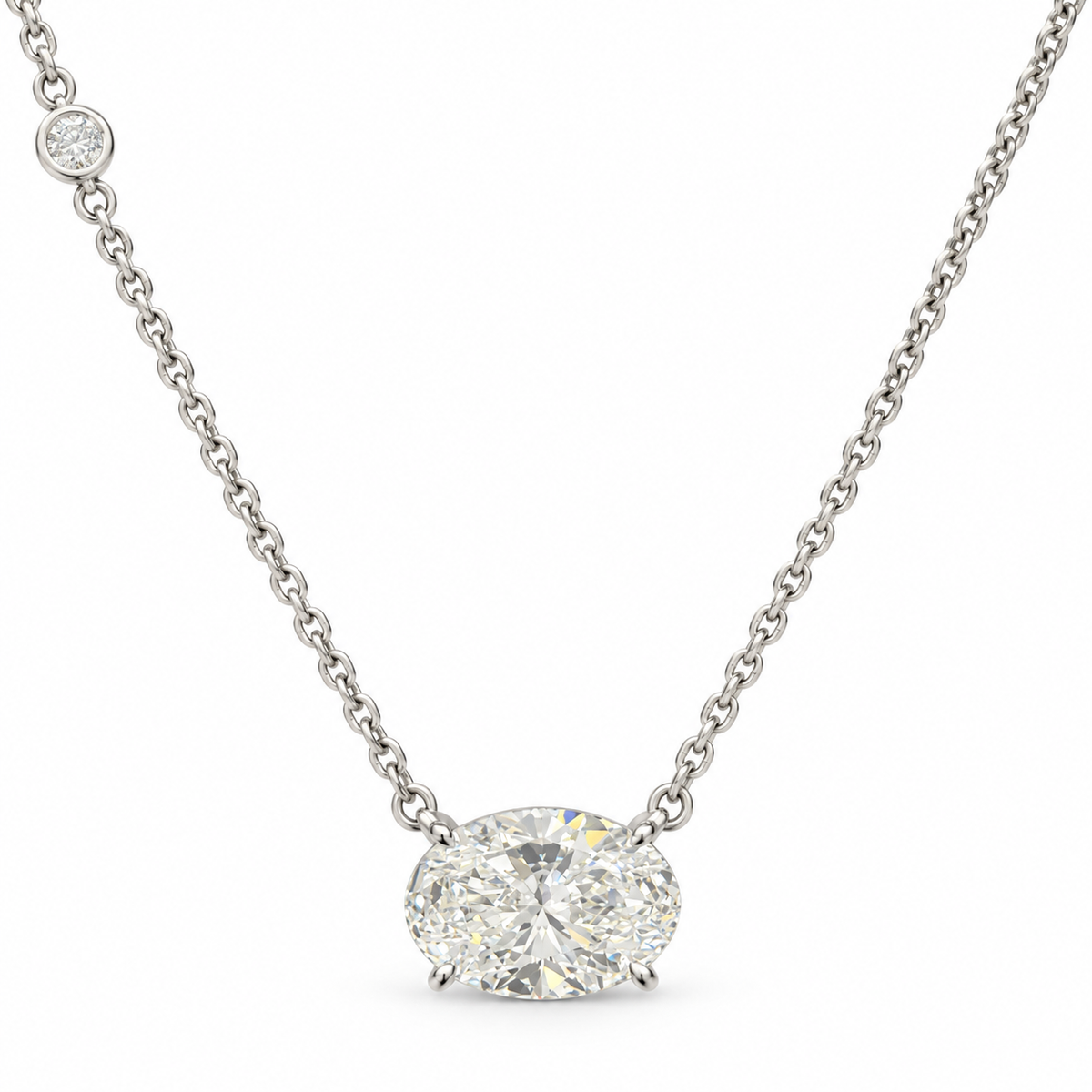 East-west oval lab-grown diamond necklace in 18K white gold with one round diamond accent, white background
