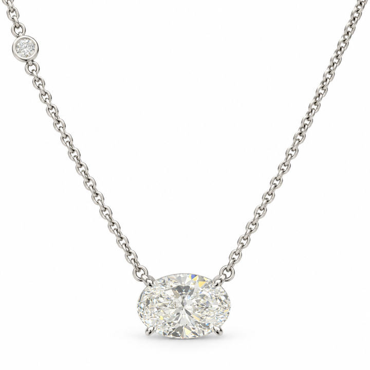 East-west oval lab-grown diamond necklace in 18K white gold with one round diamond accent, white background