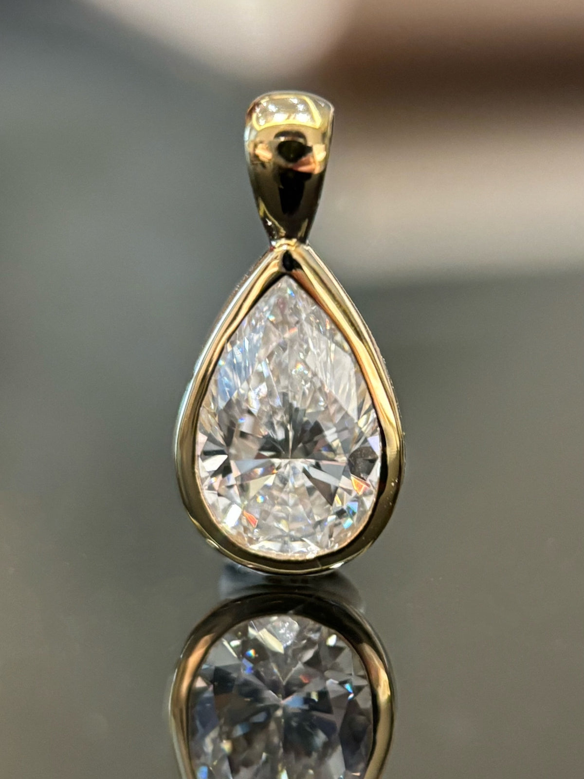 Pear bezel lab-grown diamond pendant in yellow metal, original detail view