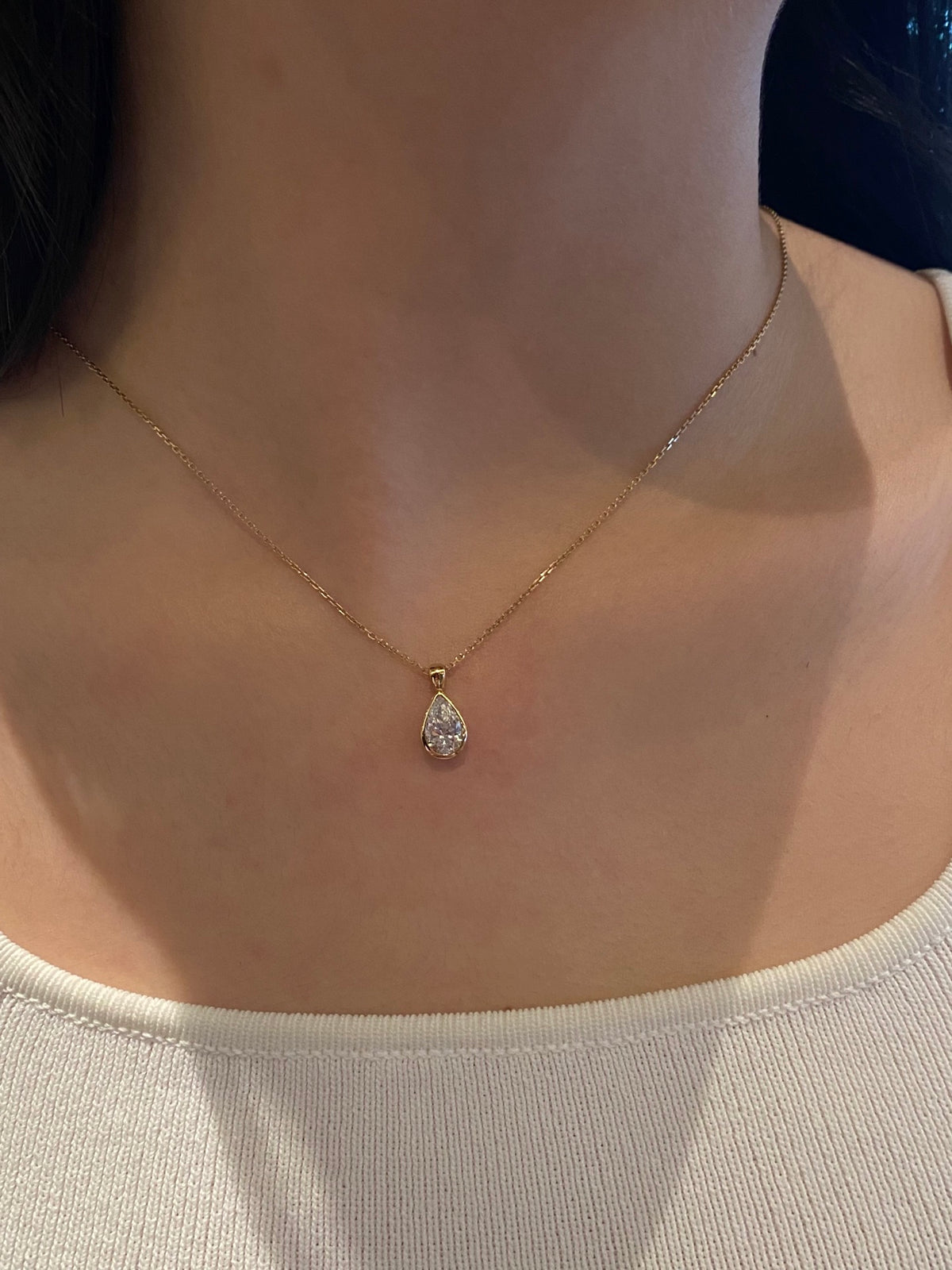 Pear bezel lab-grown diamond necklace in yellow metal, original wearing view 1