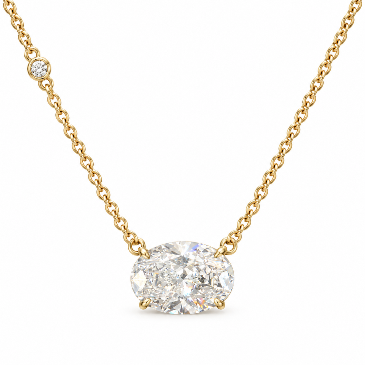 East-west oval lab-grown diamond necklace in 18K yellow gold with one round bezel accent, white background