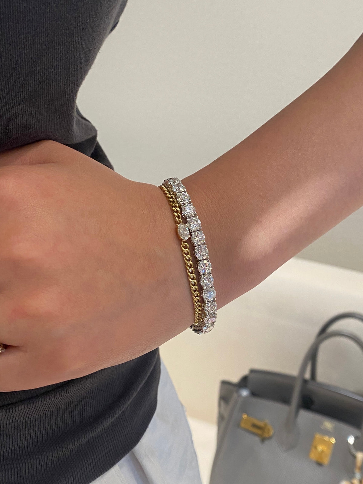 Larger white-metal round diamond tennis bracelet, original setting detail; separate gold chain bracelet not included