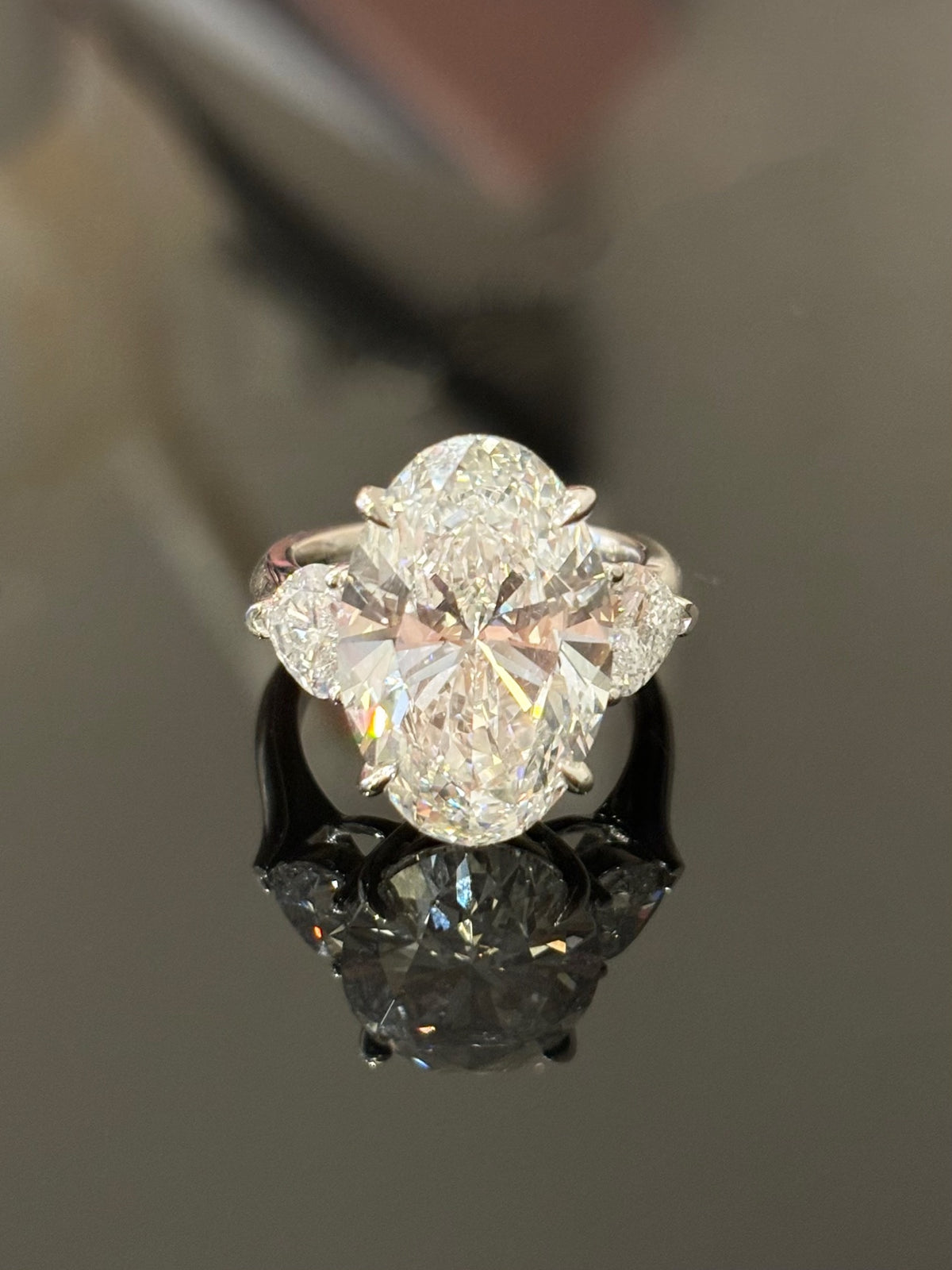 Oval lab-grown diamond ring with two heart-shaped side diamonds in white metal, original front view