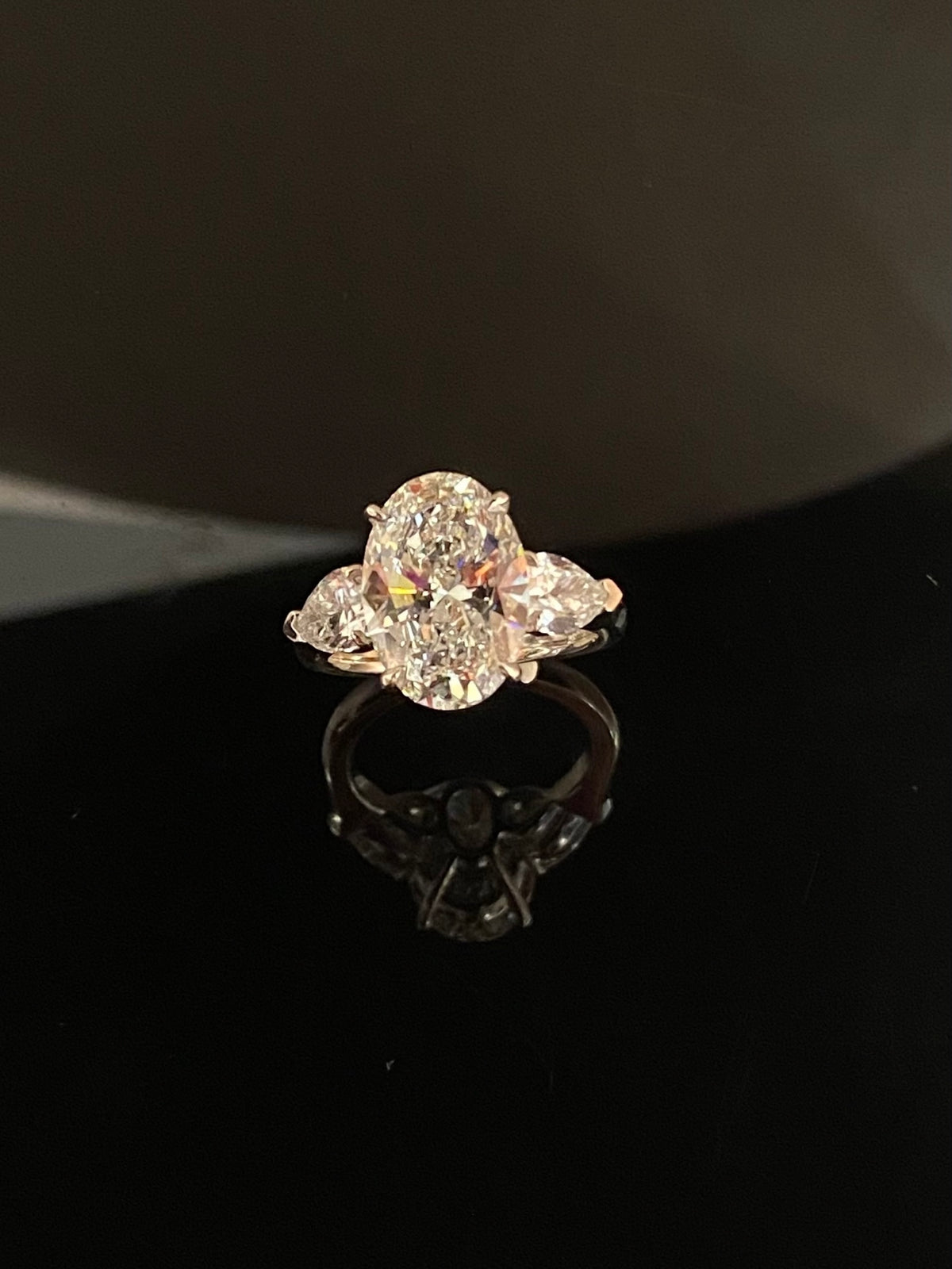 Oval and pear three-stone lab-grown diamond ring in white metal, original front view