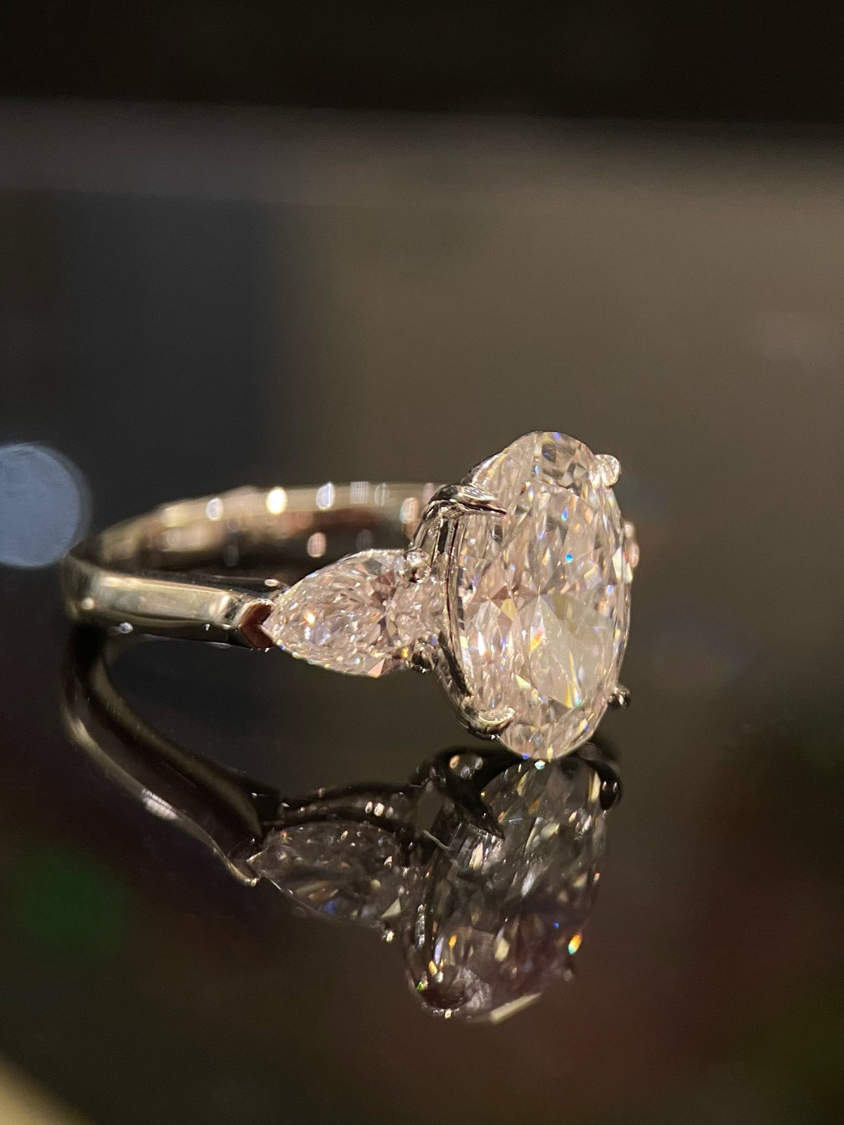 Oval and pear three-stone lab-grown diamond ring in white metal, original side view