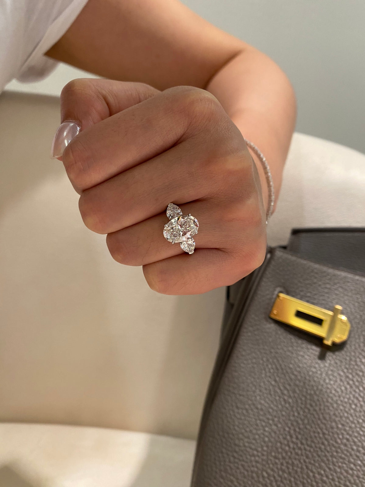 Oval and pear three-stone lab-grown diamond ring in white metal, original wearing view 2