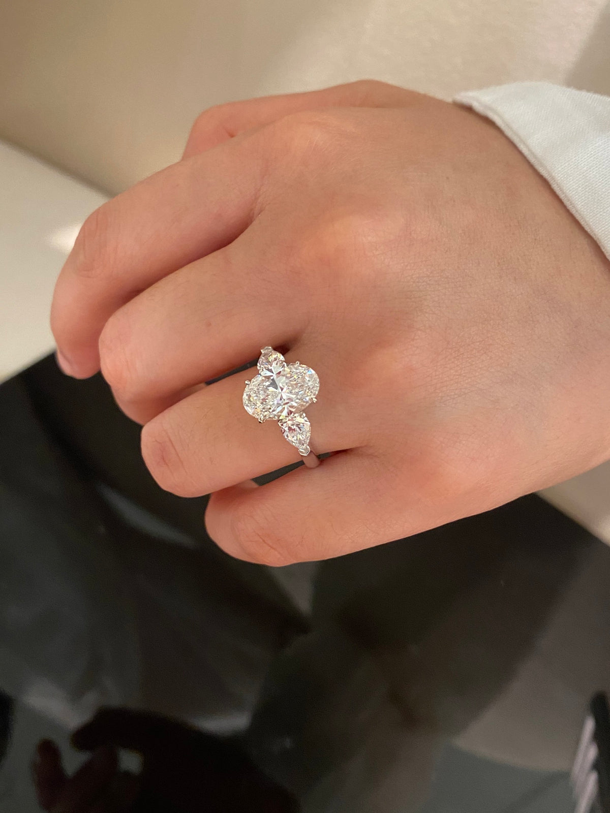 Oval and pear three-stone lab-grown diamond ring in white metal, original wearing detail