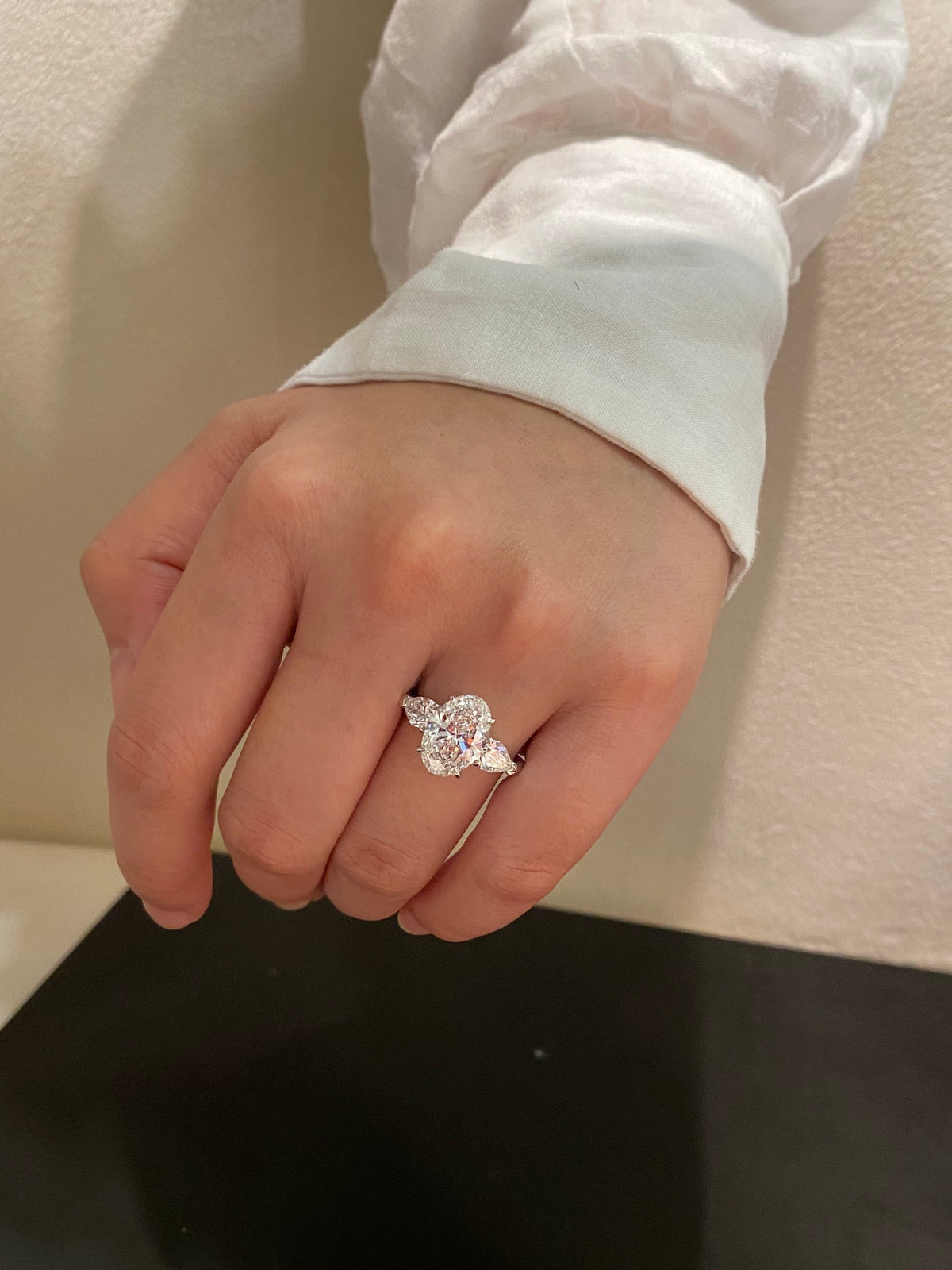 Oval and pear three-stone lab-grown diamond ring in white metal, original wearing view 3