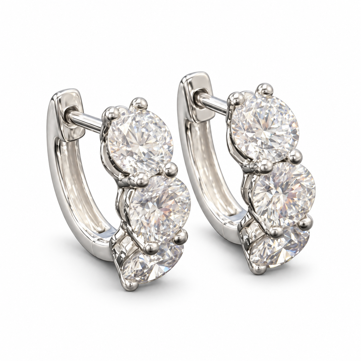 Three-round lab-grown diamond hoop earrings in 18K white gold, pair on white background