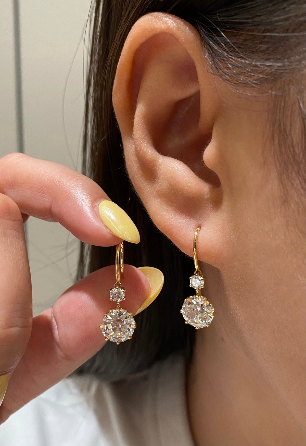 Old European-cut lab-grown diamond drop earrings in white gold, original wearing and handheld pair view 2