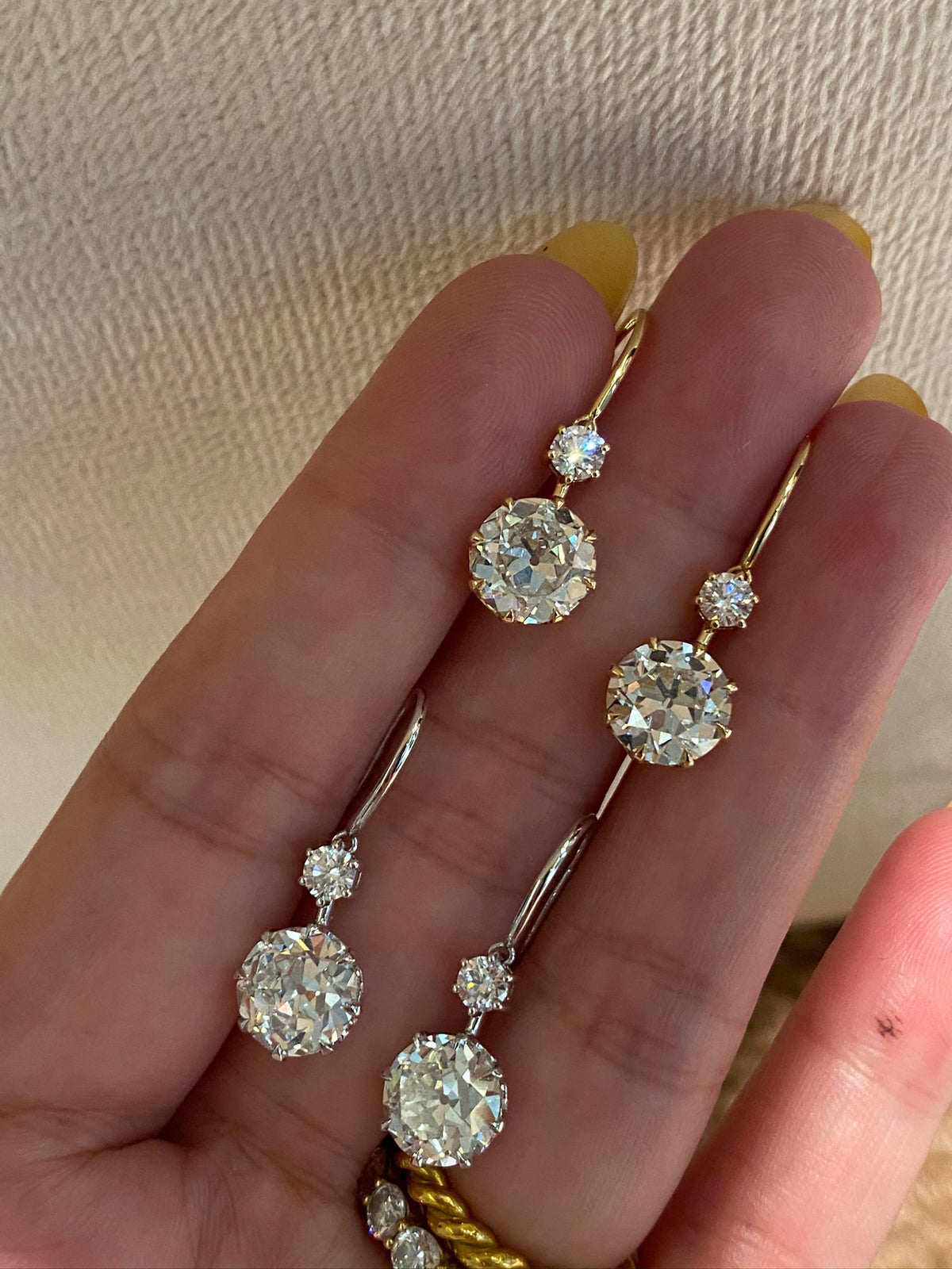 Old European-cut lab-grown diamond drop earrings, handheld yellow and white gold comparison; one pair per sale and ring not included