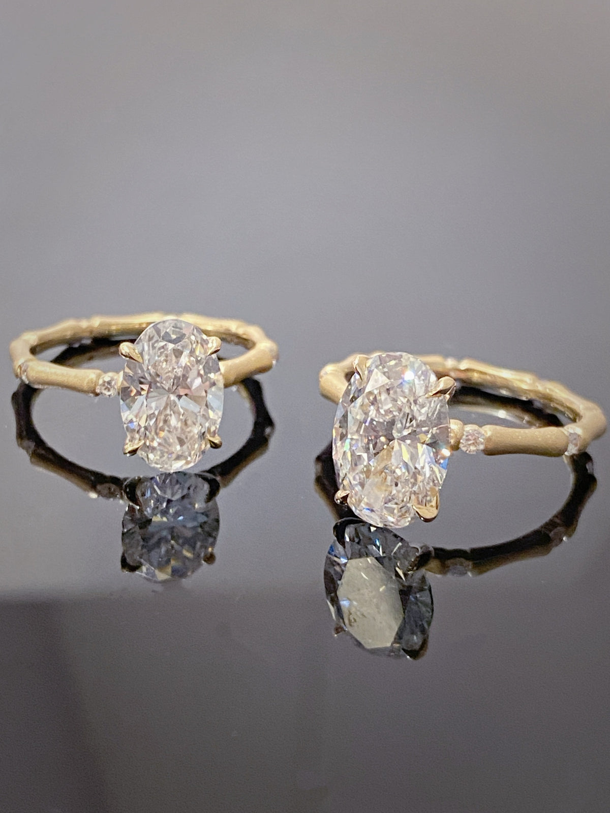 Oval lab-grown diamond bamboo-band rings in yellow metal, original two-stock comparison
