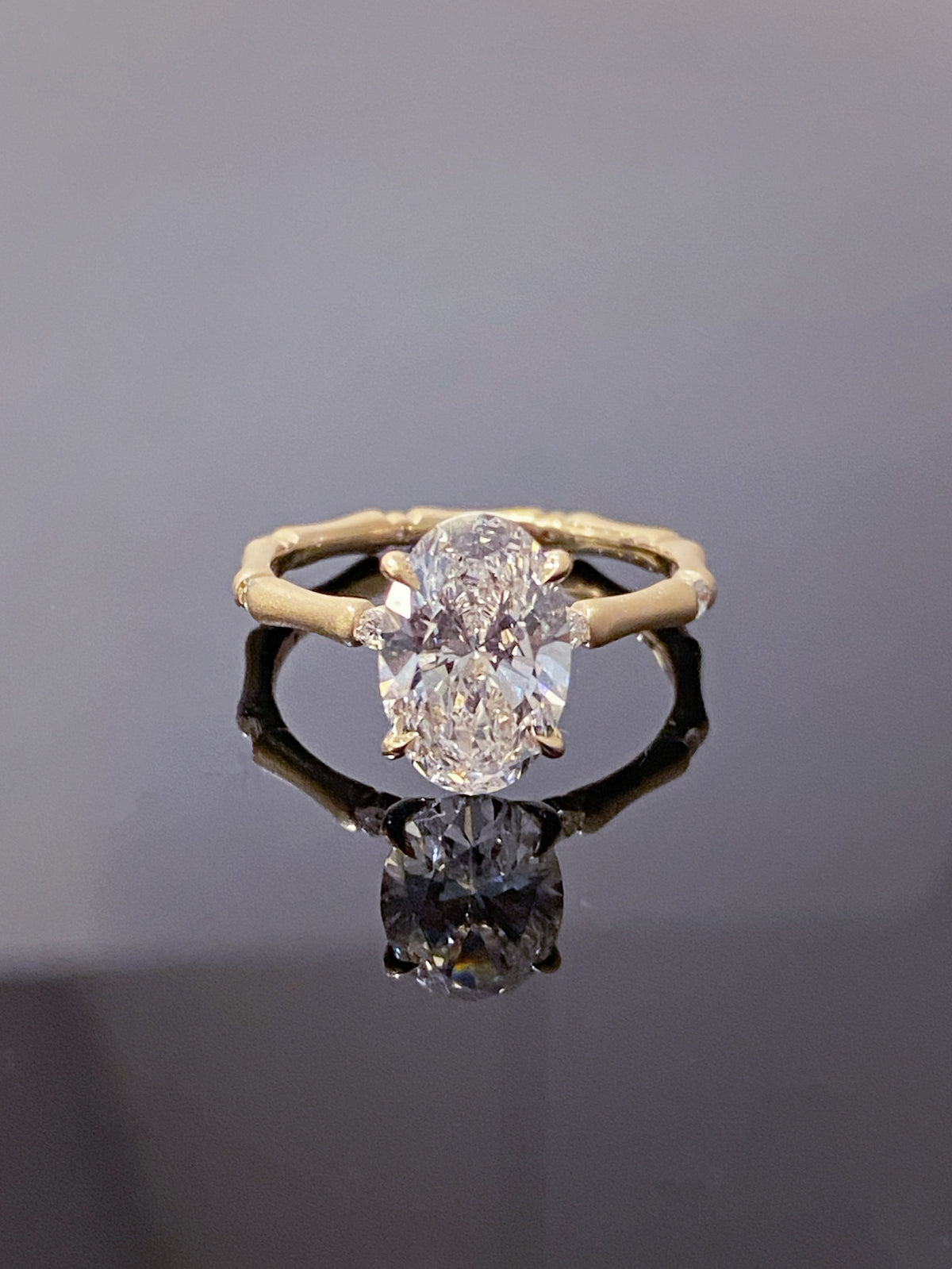 Oval lab-grown diamond bamboo-band ring in yellow metal, original frontal view
