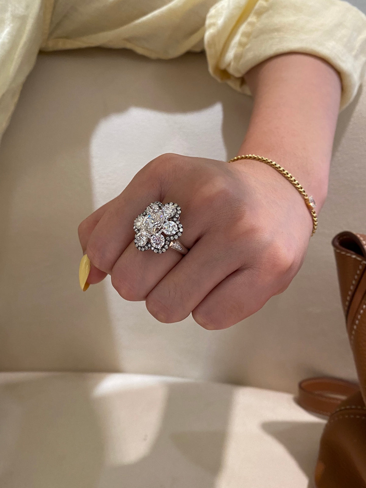 White-metal floral diamond ring, original side wearing view showing diamond-set shoulder