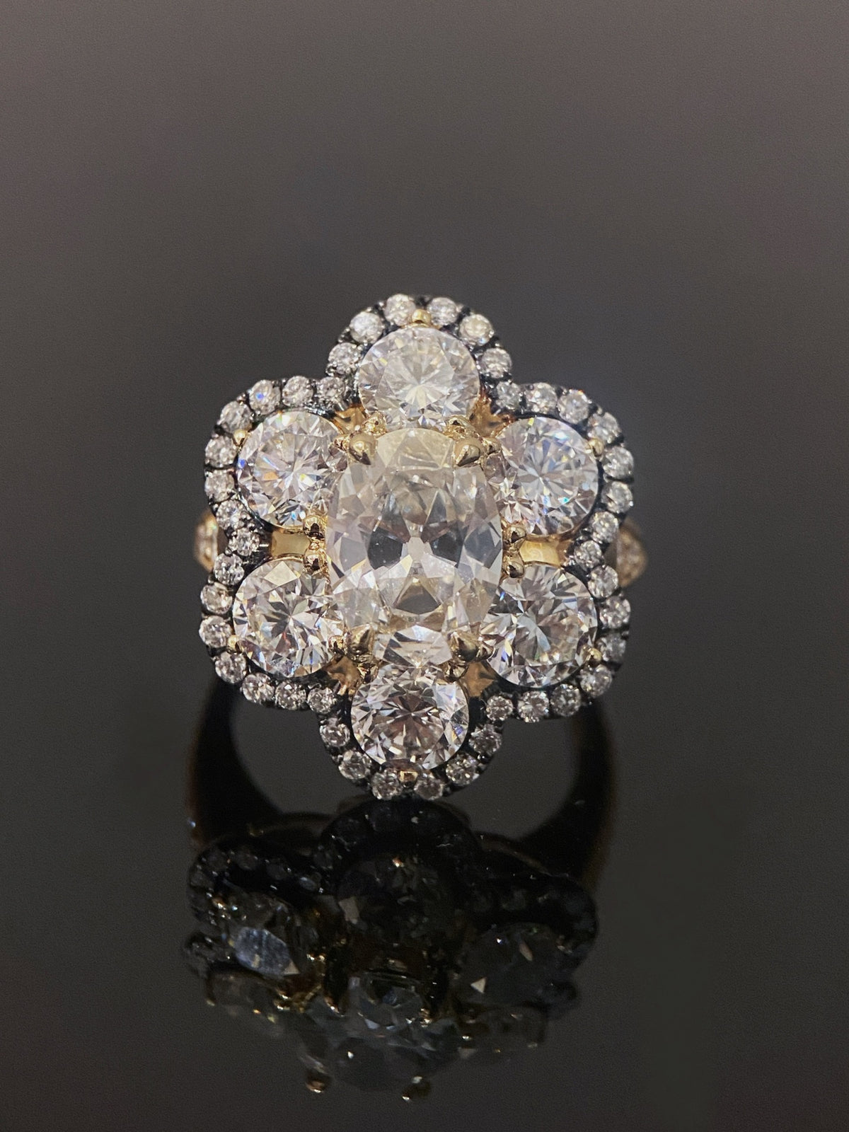 Antique-cut floral diamond ring in yellow metal with dark fine-diamond outline, original frontal view