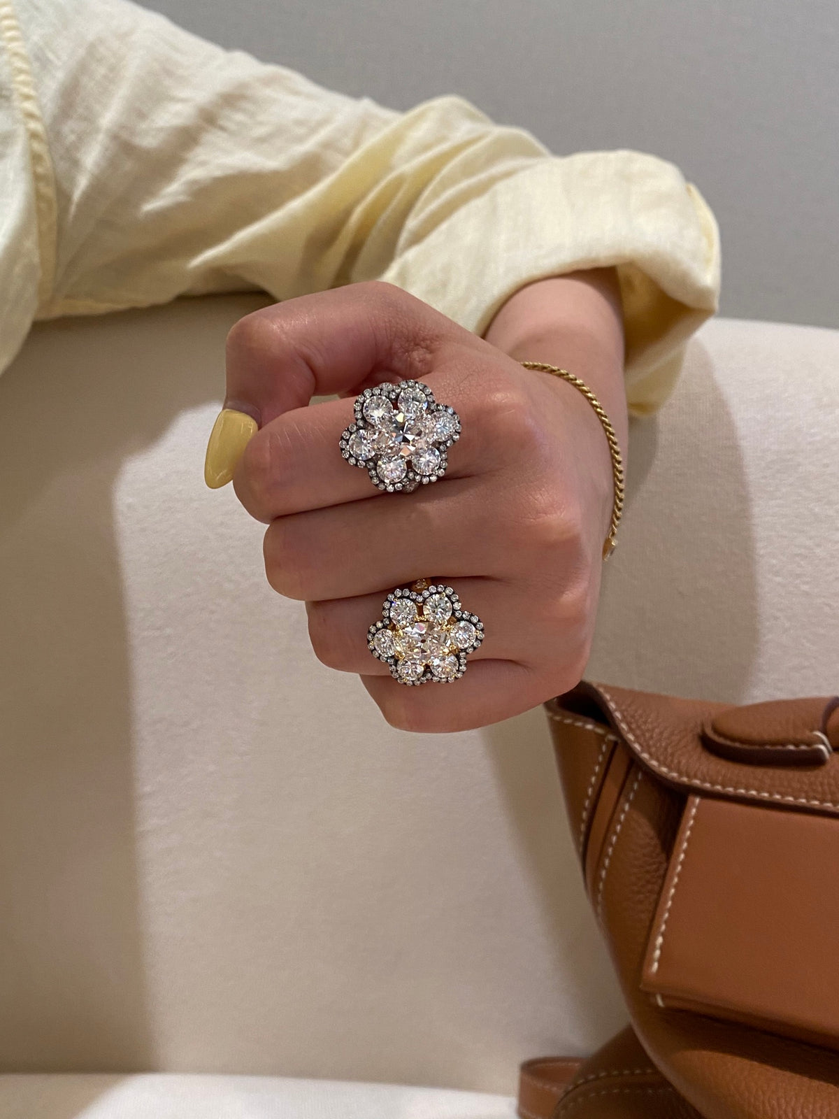 White and yellow-metal floral diamond rings, original wearing comparison1