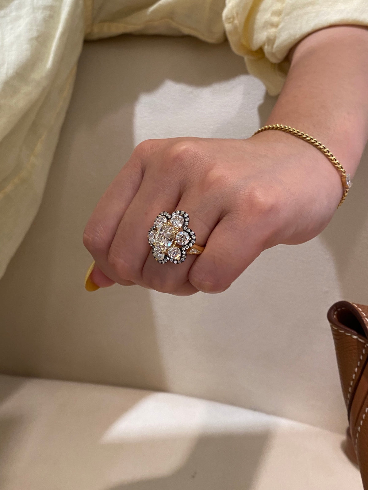Yellow-metal floral diamond ring, original side wearing view showing diamond-set shoulder