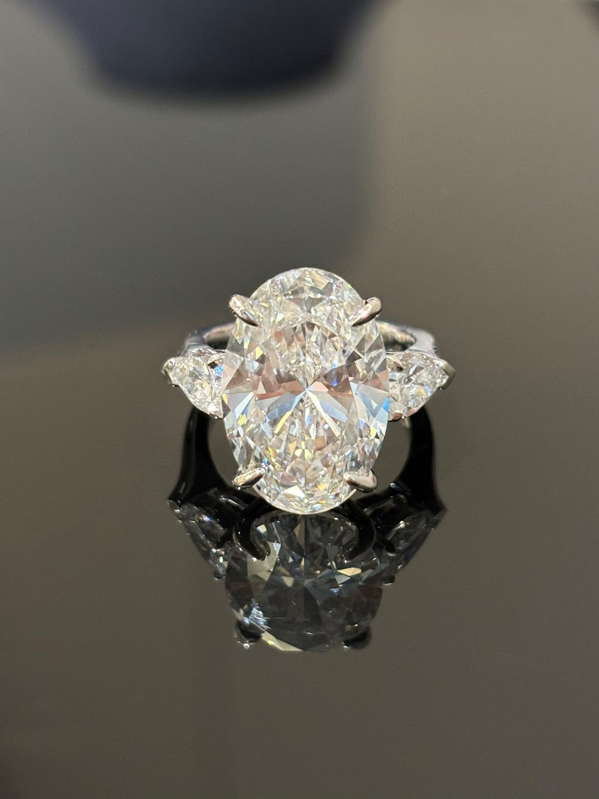 Oval and pear three-stone lab-grown diamond ring in white metal, original frontal view