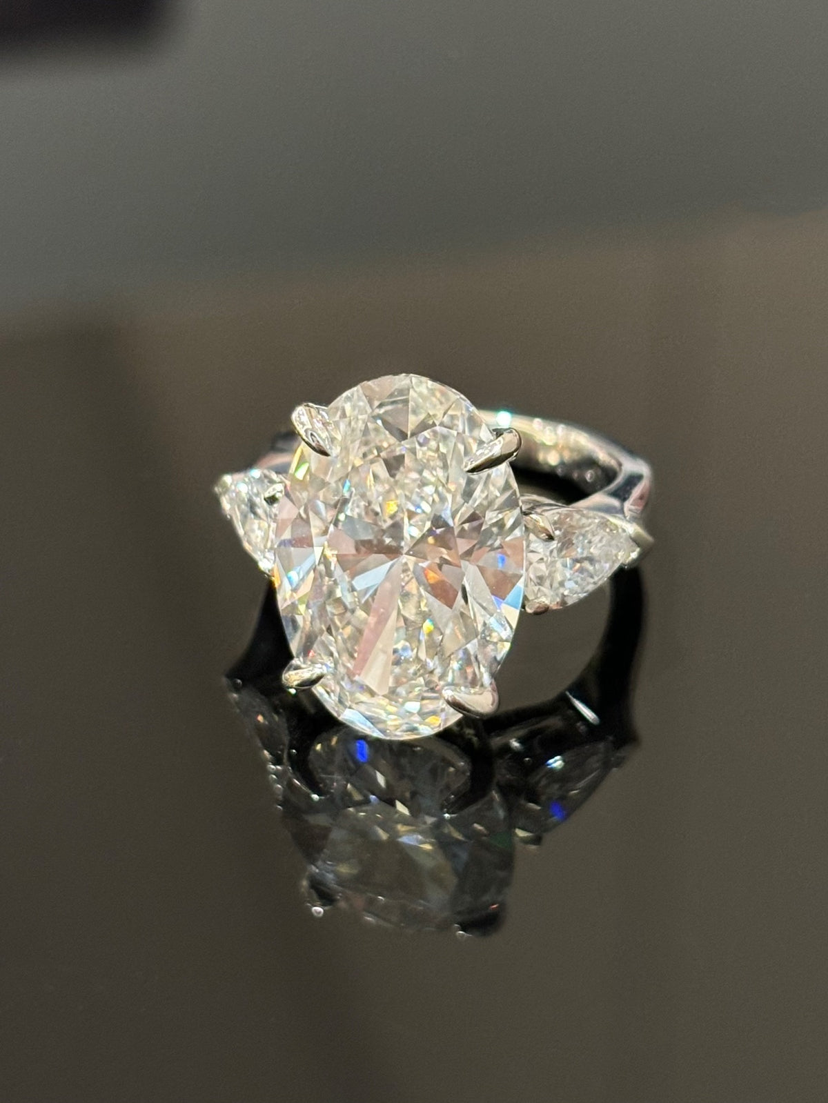 Oval and pear three-stone lab-grown diamond ring in white metal, original angled view