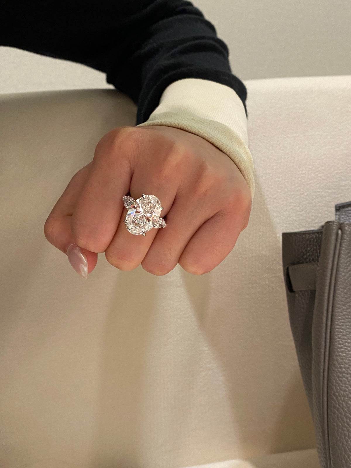 Oval and pear three-stone diamond ring, original wearing view 1