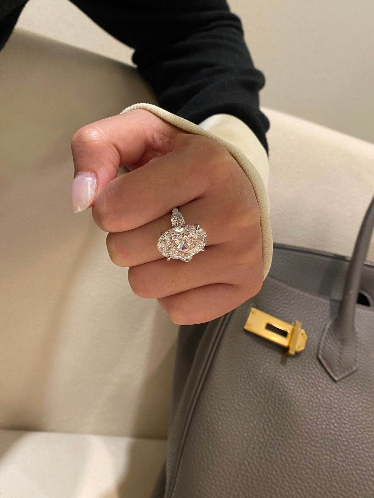 Oval and pear three-stone diamond ring, original wearing side view