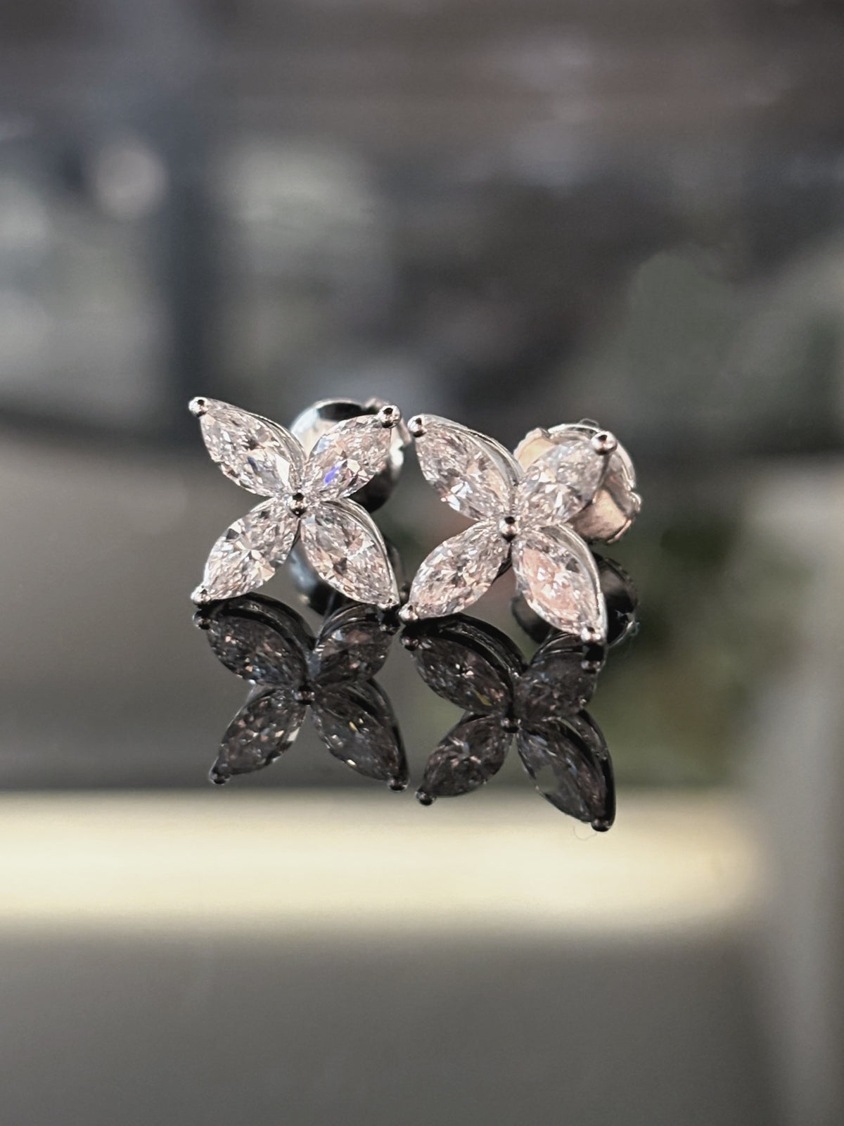 Four-petal marquise diamond stud earrings in white metal, original frontal pair view